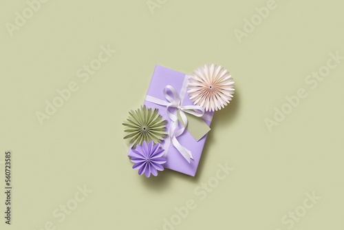Holiday present decorated with paper flowers.