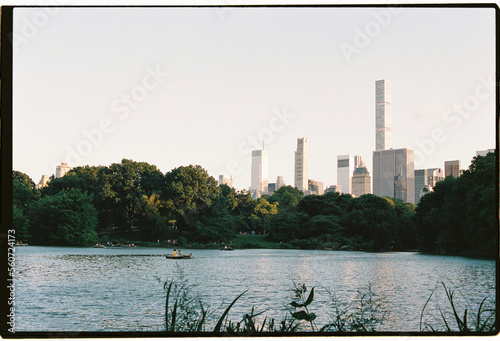 Boats at lake in Central Park with New York City skyline background