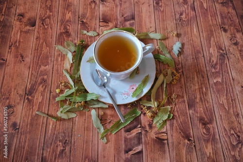 Linden tea and linden plant on wooden background.