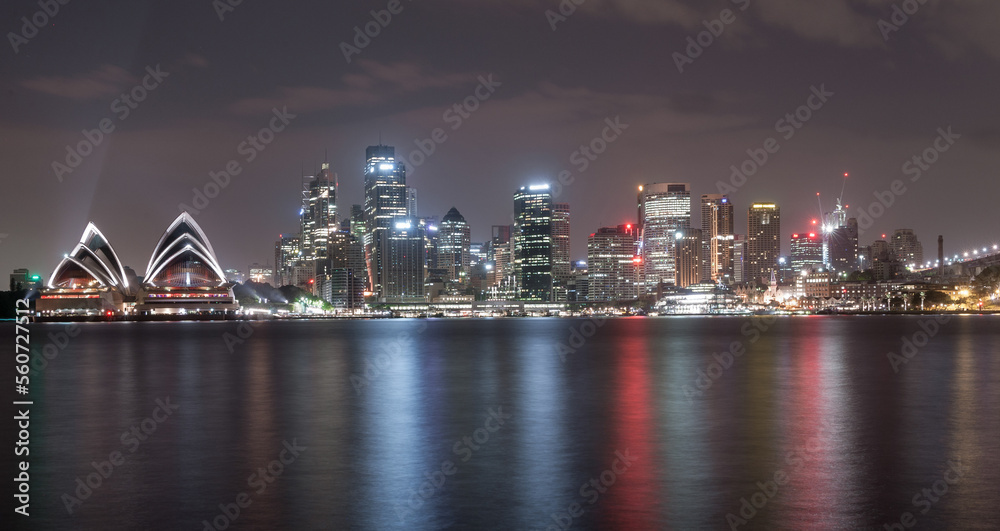 Sydney City at Night with Beautiful Downtown Skyline and Lights Reflections on Water. Opera House. Australia.