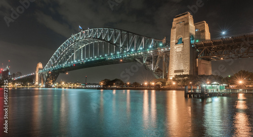Sydney Harbour Bridge at Night. Long Exposure. Cityscape In Background. Flowing Sky and Reflection on Water. Australia