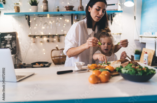 Mother and daughter preparing healthy breakfast at kitchen