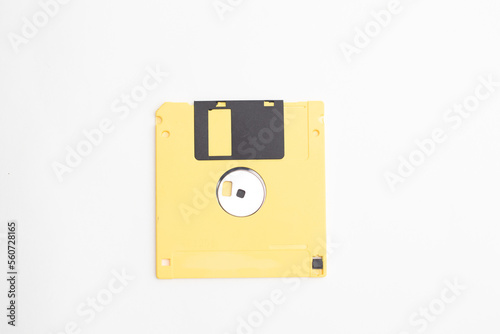 Yellow floppy diskette on white background