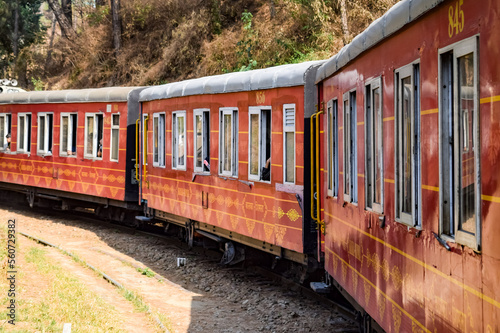 Toy Train moving on mountain slopes, beautiful view, one side mountain, one side valley moving on railway to the hill, among green natural forest. Toy train from Kalka to Shimla in India, Indian Train