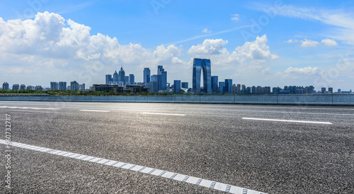 Asphalt road and city skyline with modern building scenery in Suzhou  Jiangsu Province  China.