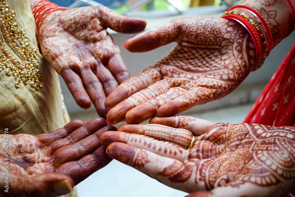 Beautiful woman dressed up as Indian tradition with henna mehndi design on her both hands to celebrate big festival of Karwa Chauth, Karwa Chauth celebrations by Indian woman for her husband Beautiful woman dressed up as Indian tradition with henna mehndi design on her both hands to celebrate big festival of Karwa Chauth, Karwa Chauth celebrations by Indian woman for her husband