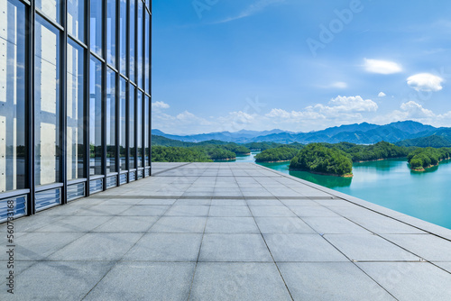Empty square floor and glass wall with mountain background
