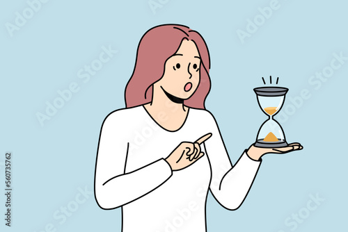 Astonished woman look at hourglass surprised with time passing. Amazed girl hold sand clock in hands feel frustrated with deadline. Vector illustration. 