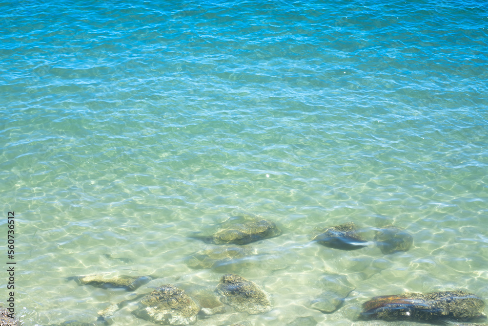 Ocean wave on tropical beach with golden sand and ripple of water splash from emerald blue-green sea water during summer vacation. Ocean wave on tropical beach with golden sand and ripple of water splash from emerald blue-green sea water during summer vacation.