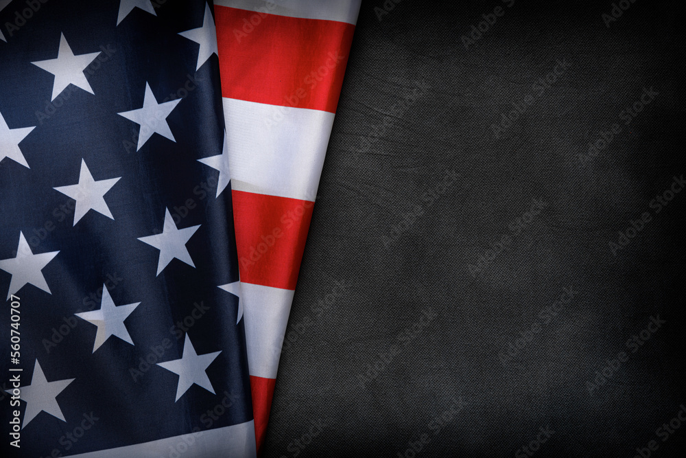 Fototapeta premium USA flag on a dark background. American flag on the background of a dark canvas for a patriotic concept and national celebrations.