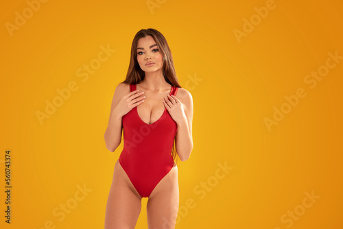 Print op canvas Attractive brunette woman posing in red swimwear,  summer style
