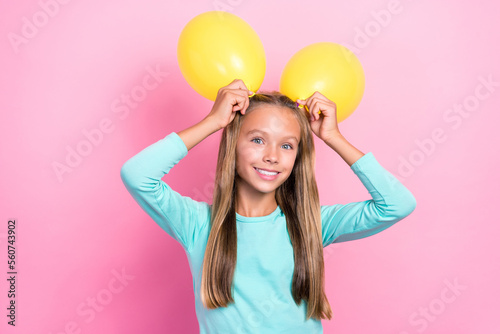 Closeup photo of young little pretty cute small schoolkid girl toothy smile hold yellow air balloon bunny positive enjoy event isolated on pink color background