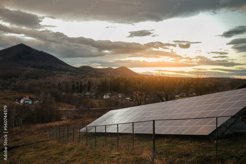 solar panels on the background of the mountains and the setting sun