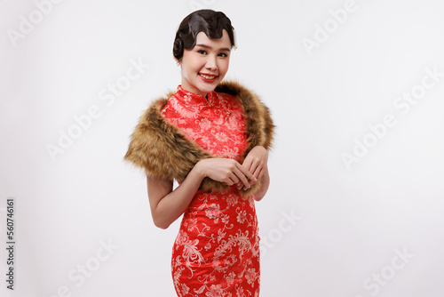 Smiling young beautiful woman in traditional dress on isolated white background.