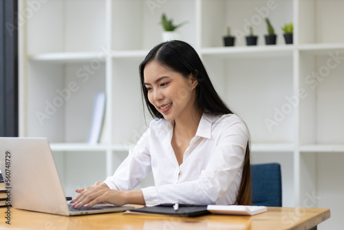 Portrait of beautiful asian businesswoman working with laptop in office.