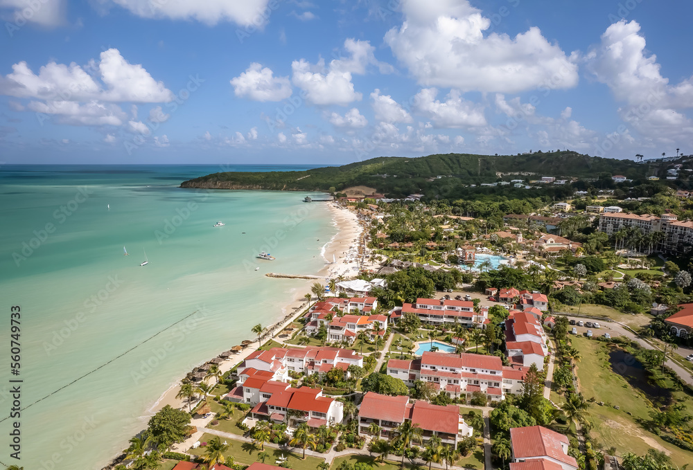 The drone aerial view of Dickenson Bay beach, Antigua. Dickenson Bay is on the Northwestern coast of Antigua and is the most developed beach on the island.