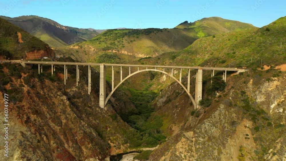 Aerial Shot Of Famous Bixby Canyon Bridge Amidst Mountains, Drone Flying Backwards Over Coastline At Beach - San Francisco, California Aerial Shot Of Famous Bixby Canyon Bridge Amidst Mountains, Drone Flying Backwards Over Coastline At Beach - San Francisco, California