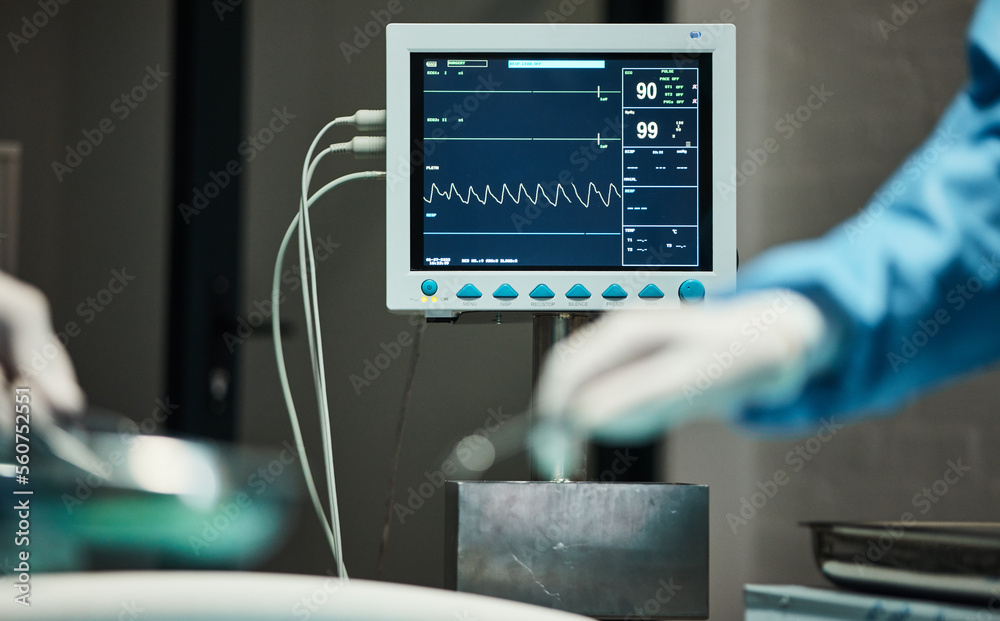 Electrocardiogram monitor, hands of doctors with scalpel for surgery, healthcare or medical support. Zoom, screen or nurse hand in theater for trust, insurance or surgeon in hospital operation room Electrocardiogram monitor, hands of doctors with scalpel for surgery, healthcare or medical support. Zoom, screen or nurse hand in theater for trust, insurance or surgeon in hospital operation room