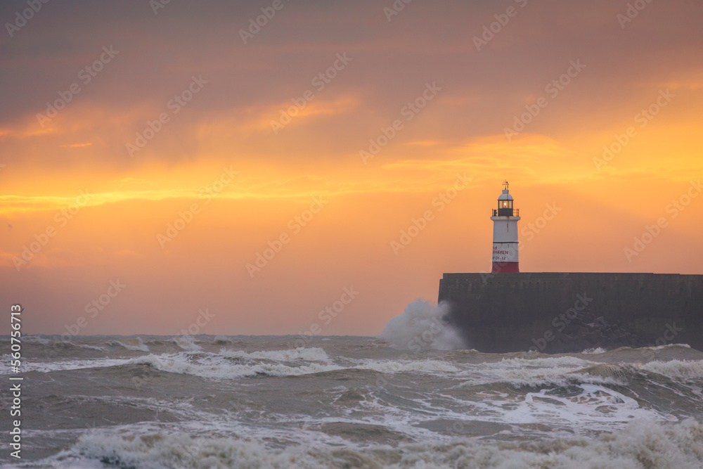 kite surfing on choppy seas during sunset at Newhaven lighthouse and east beach Seaford east Sussex south east England