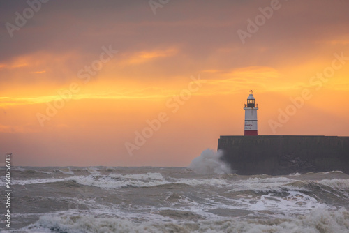 kite surfing on choppy seas during sunset at Newhaven lighthouse and east beach Seaford east Sussex south east England