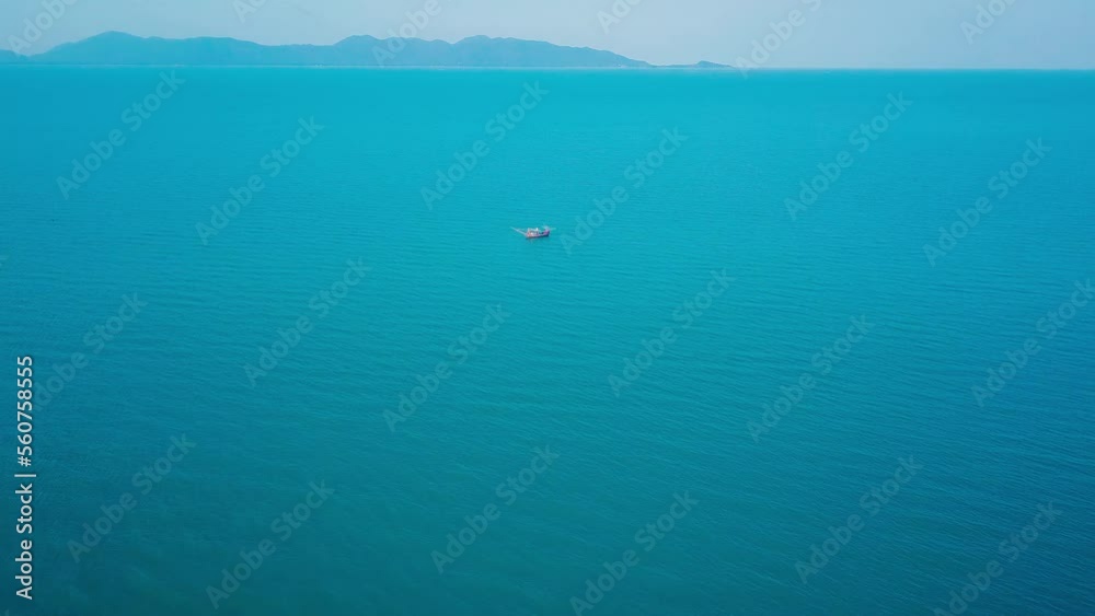 Aerial view drone tracking a tourist thai longtail fishing boat in phuket islands,Amazing andaman sea in Phuket Thailand on a sunny morning with beautiful sea background Aerial view drone tracking a tourist thai longtail fishing boat in phuket islands,Amazing andaman sea in Phuket Thailand on a sunny morning with beautiful sea background
