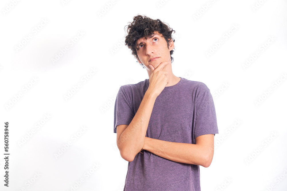 Young Hispanic man thinking looking up. Isolated on white background. Young Hispanic man thinking looking up. Isolated on white background.