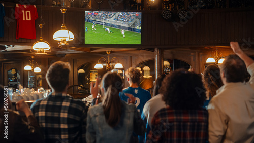 Fényképezés Group of Friends Watching a Live Soccer Match on TV in a Sports Bar