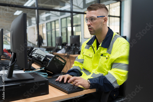 Male engineer using desktop computer for training Programmable logic controller or Programmable controller in the manufacturing automation and robotics academy room photo