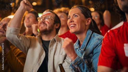 Group of Multicultural Friends Watching a Live Soccer Match in a Sports Bar. Focus on Beautiful Female. Young People Celebrating When Team Scores a Goal and Wins the Football World Cup.