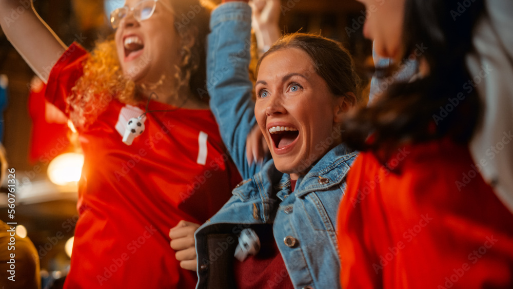 Three Female Friends Watching a Live Soccer Match on TV in a Sports Bar. Happy Girls Cheering and Shouting. Young Fans Celebrating When Team Scores a Goal and Wins the Football World Cup.