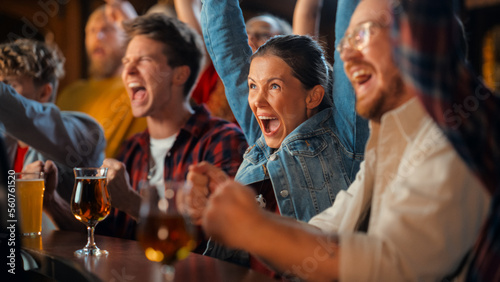 Group of Diverse Friends Cheering for Their Team, Drinking Beer at a Pub Counter. Supportive Fans Cheering, Applauding and Shouting. Joyful Friends Celebrate Victory After the Goal. photo