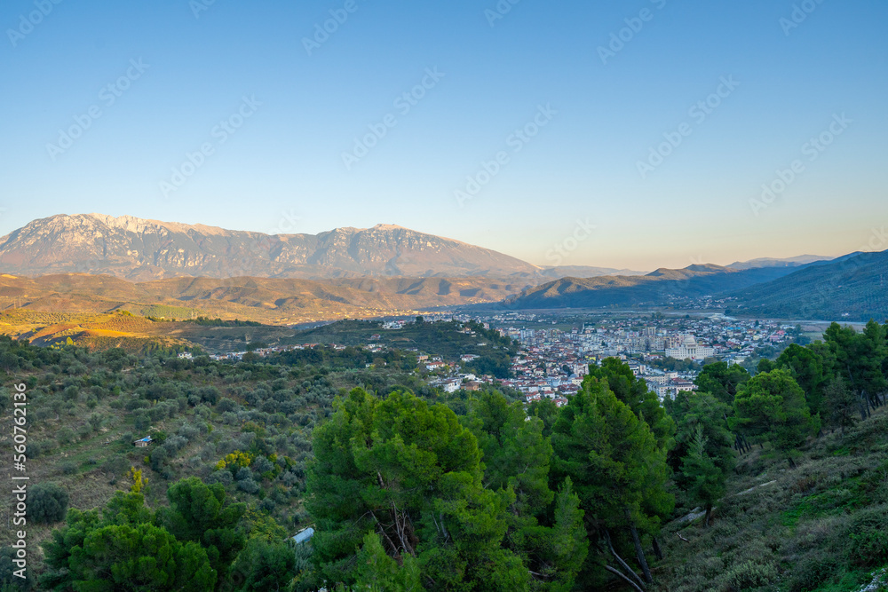 View to Berat, historic city in the south of Albania at night with all lights flashing and white houses gathering on a hill. Captured during blue hour with the sky full of stars.