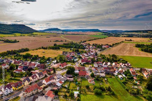 Obraz na płótnie Aer ial view of a German village surrounded by meadows, farmland and forest in Germany. w salonie