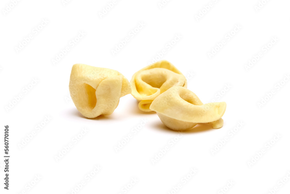 Tortellini stuffed pasta isolated on white background, closeup. Tortellini with raw prosciutto. Italian food Tortellini stuffed pasta isolated on white background, closeup. Tortellini with raw prosciutto. Italian food