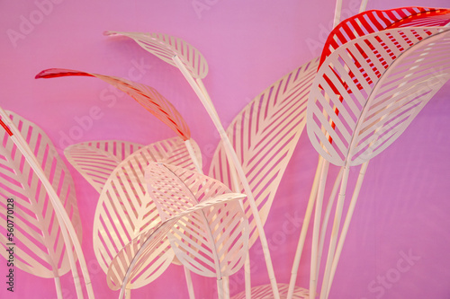White leaf decorations on a pink background
