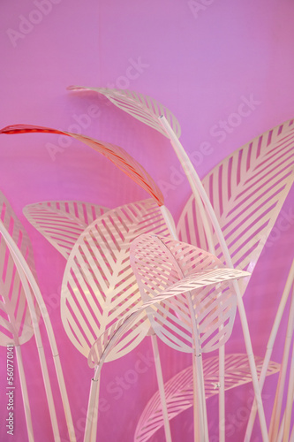 White leaf decorations on a pink background