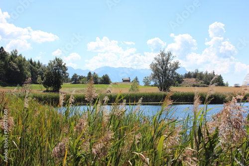 Beautiful panoramic view over Lake 'Lac du Siguret' This water is a remnant of the last glacial area that is 6000 years old. In the distance a mountain house, alpine landscape in the Hautes-Alpes. photo