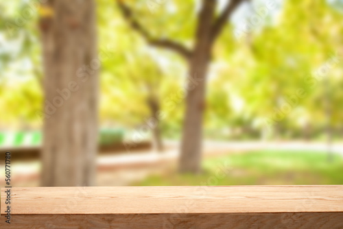 light wooden table on blurred nature bokeh background