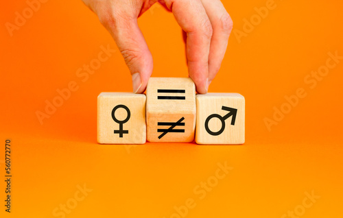 Wallpaper Mural Symbol for gender equality. Turned a cube and changed a unequal sign to a equal sign between symbols of men and women. Beautiful orange table orange background, copy space. Gender equality concept. Torontodigital.ca