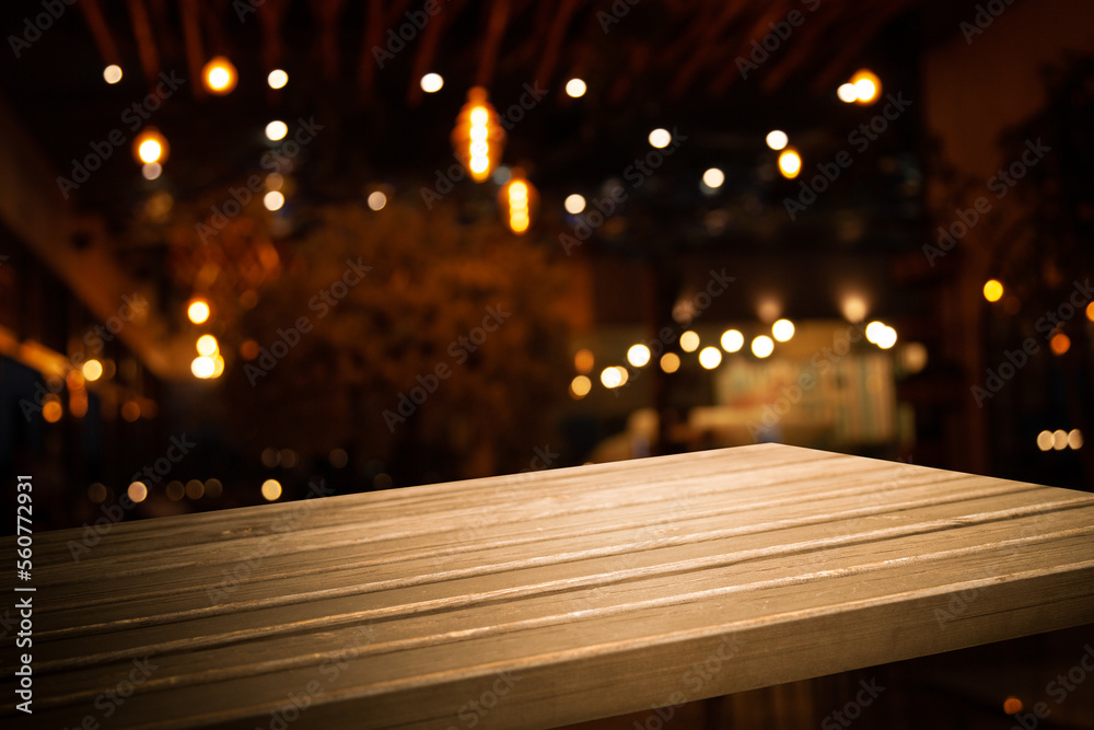 empty wooden brown table on blurred light gold bokeh cafe restaurant bar, place for your products on the table. Abstract background