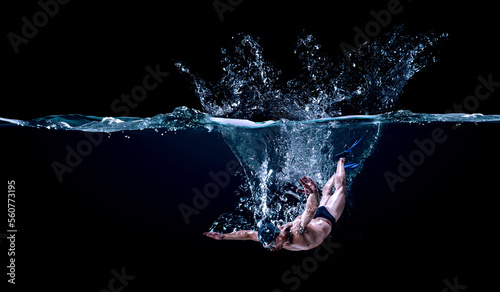 Professional man swimmer on a wave
