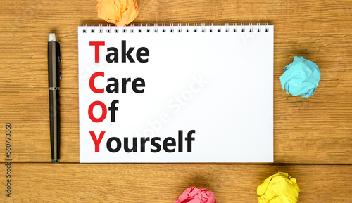 TCOY take care of yourself symbol. Concept words TCOY take care of yourself on white note on beautiful wooden background. Business TCOY take care of yourself concept. Copy space.