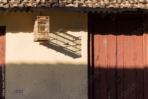 Birdcage with bird outside house, Trinidad, Sancti Spiritus Province, Cuba photo