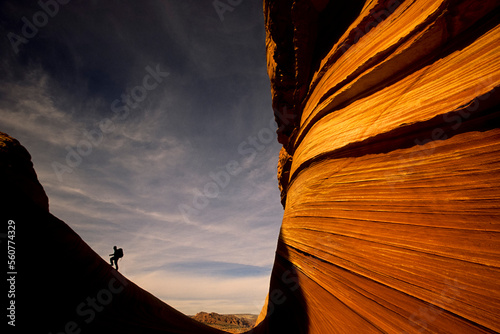 A hiker climbs a ridgeline at 
