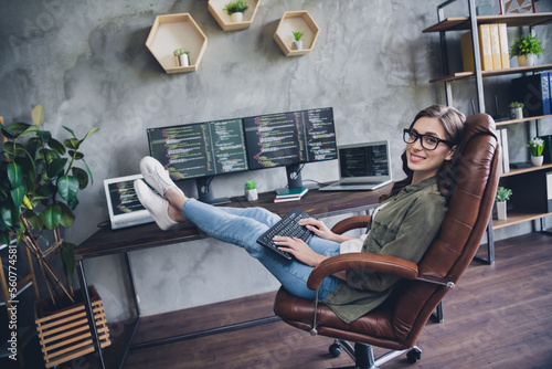 Photo of smiling cheerful lady freelancer wear glasses creating new start up modern gadget indoors workstation workshop
