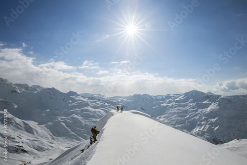 Two skiers seeking out a line on the border of a ridge photo