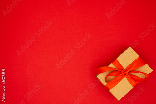 Gift box tied with red ribbon. Holiday banner. Place for text, banner, top view. The concept of the weddings, birthday and other holidays