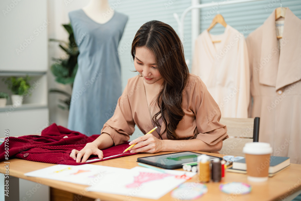 Asian Woman Fashion Designer Stylish Artist or creative designer drawing on sketch book with new project design Asian Woman Fashion Designer Stylish Artist or creative designer drawing on sketch book with new project design
