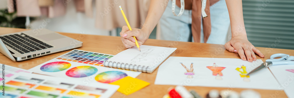 Fashion Designer Stylish Artist or creative designer drawing on sketch book with new project design working in studio