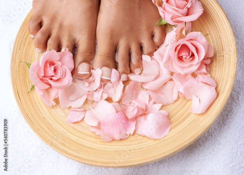 Pedicure, beauty and feet of a woman with flowers for cleaning, treatment and detox. Spa, dermatology and above foot of a model with a floral, cosmetic and natural grooming with roses for luxury